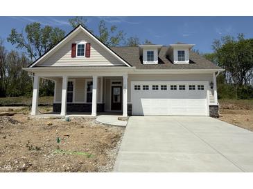 Charming single-Gathering home features a covered front porch and a two-car garage at 14383 Coyote Ridge Dr, Noblesville, IN 46060