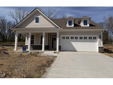 Charming single-story home with inviting front porch, attached garage, and a well-lit driveway at 14383 Coyote Ridge Dr, Noblesville, IN 46060