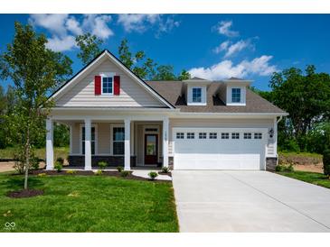 Charming single-Gathering home with a manicured lawn, two car garage, and inviting front porch at 14383 Coyote Ridge Dr, Noblesville, IN 46060