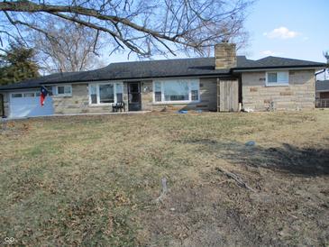 Charming stone home with a well-maintained lawn and a classic chimney at 1459 S Josephine St, Martinsville, IN 46151