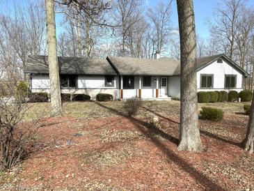 Charming single-story home with mature trees, a well-maintained lawn, and a welcoming front entrance at 19533 Justin Morgan Dr, Westfield, IN 46074