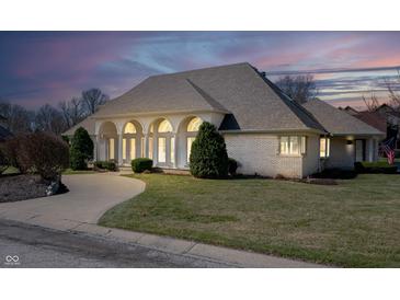 Attractive single story home features a large front yard, beautiful windows, and lovely landscaping at 6520 Forrest Commons Blvd, Indianapolis, IN 46227