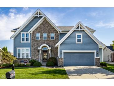 Charming two-story home with a brick facade, blue siding, and well-manicured lawn at 664 Hythe Way, Westfield, IN 46074