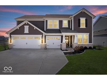 Beautiful two-story home featuring a three-car garage, landscaped yard, and welcoming front porch at 8861 Linton Ln, Brownsburg, IN 46112