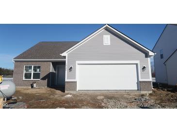 Charming single-story home features a two-car garage, brick accents, and horizontal siding under a blue sky at 10126 Camp Creek Way, Indianapolis, IN 46229