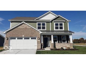 Beautiful two-story home with a modern exterior, featuring a two-car garage, stylish brick, and siding accents at 1670 Crossley St, Fortville, IN 46040
