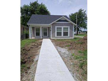 Charming home with a new concrete walkway and freshly landscaped front yard at 1974 Ralston Ave, Indianapolis, IN 46218