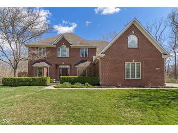 Charming brick two-story home with a manicured lawn and mature landscaping at 2163 Laurel Leaf Ln, Avon, IN 46123