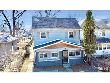 Charming two-story home featuring light blue siding, wood accents, and well-maintained landscaping at 2839 E 19Th St, Indianapolis, IN 46218