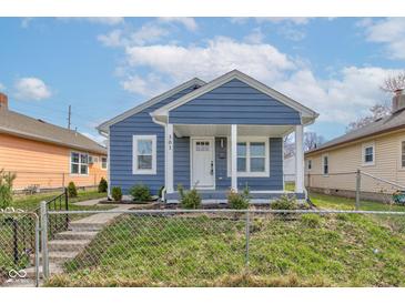 Charming blue home with white trim and covered porch exudes curb appeal and a welcoming entrance at 301 Villa Ave, Indianapolis, IN 46201