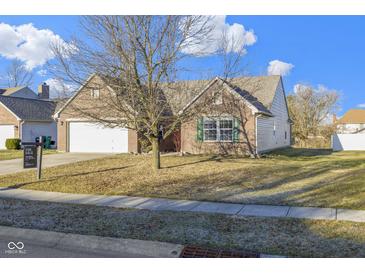 Charming single-story brick home featuring an attached two-car garage and a well-maintained front yard at 4062 S Meadow Wood Ct, New Palestine, IN 46163