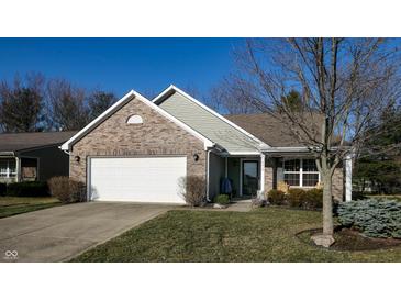 Charming home featuring a two-car garage, brick facade, and manicured front lawn at 4618 Angelica Dr, Indianapolis, IN 46237