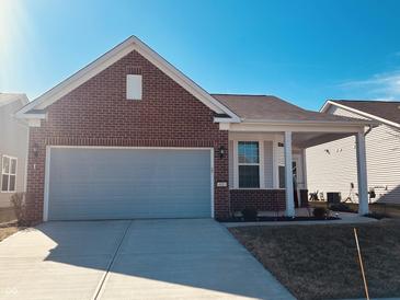 Charming brick and siding home with an attached garage and well-maintained lawn at 4889 Lilium Dr, Plainfield, IN 46168
