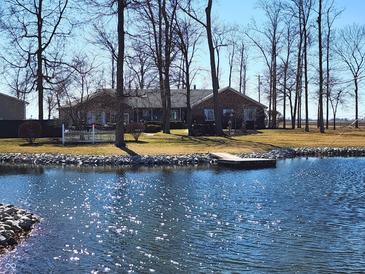Beautiful brick home on lakefront property with mature trees and personal dock at 551 E 600 S, Lebanon, IN 46052