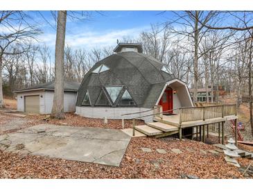 Unique dome home with a deck, red front door, and a detached garage surrounded by trees at 6655 Gopher Dr, Nineveh, IN 46164