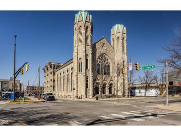 Stunning stone church with unique architecture and two prominent towers against a clear blue sky at 802 N Meridian St # 103, Indianapolis, IN 46204