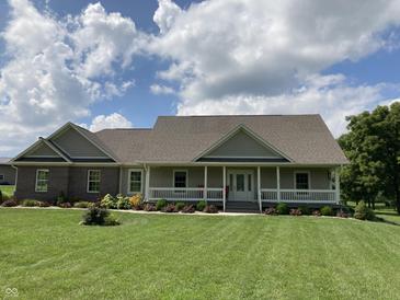 Charming single-story home featuring a welcoming front porch, well-maintained lawn, and tasteful landscaping at 1002 Plummer Rd, Martinsville, IN 46151