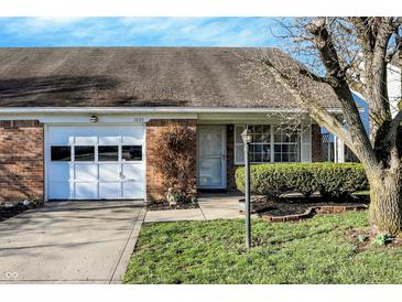 Charming single-story home with a brick facade, attached garage, and well-maintained landscaping at 1035 Ina Cir, Franklin, IN 46131