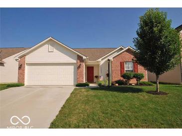 Charming single-story home featuring a well-manicured lawn, attached two-car garage, and a welcoming front entrance at 11026 Cool Winds Way, Fishers, IN 46037