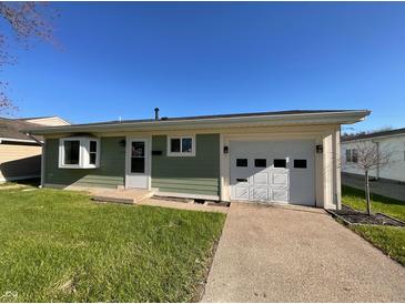 Charming, light green, single-story home with an attached garage and well-maintained lawn at 1378 South St, Noblesville, IN 46060