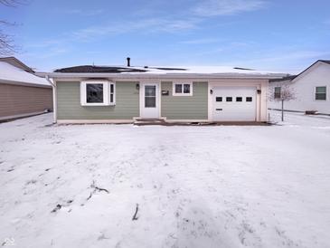 Charming single story home with a light green exterior and a snowy front yard at 1378 South St, Noblesville, IN 46060