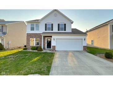 Two-story home featuring a brick and vinyl facade, attached two-car garage, and well-manicured lawn at 3153 Underwood Dr, Whiteland, IN 46184