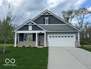 Charming home with a well-manicured lawn, a two-car garage, and stylish gray siding at 3912 Bamboo Branch Dr, Clayton, IN 46118