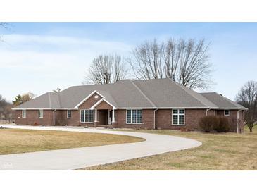 Stunning brick home features a circular driveway and meticulously maintained lawn at 3949 W 250 N, Anderson, IN 46011