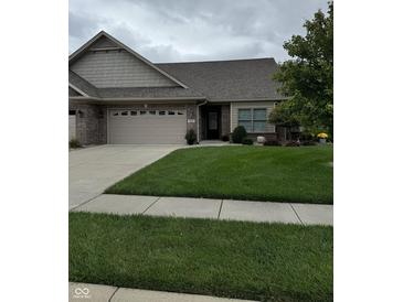 Charming single-story brick home with a well-manicured lawn and an attached two-car garage at 5002 Delray Dr, Columbus, IN 47203