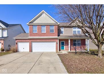 Charming two-story home with a brick facade and a three-car attached garage at 5402 Basin Park Dr, Indianapolis, IN 46239