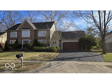 Charming two-story brick home with a well-maintained lawn and mature landscaping at 7474 Oakland Hills Dr, Indianapolis, IN 46236