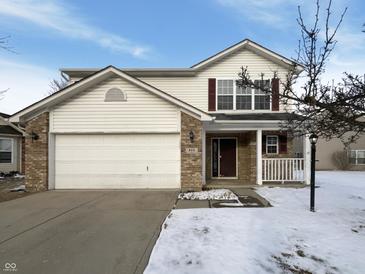Charming two-story home features a brick and siding exterior, attached garage, and well-maintained landscaping at 825 Treyburn Green Dr, Indianapolis, IN 46239