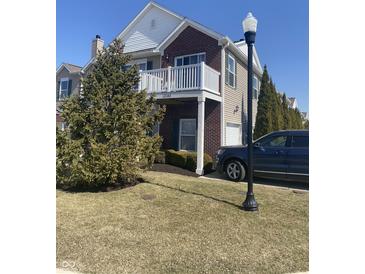 Charming two-story home with brick accents, white trim, a private balcony, and well-maintained landscaping at 12145 Bubbling Brook Dr # 600, Fishers, IN 46038