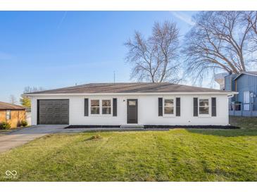 Charming ranch home featuring white siding, black shutters and a well-maintained front lawn, great curb appeal at 1319 Brookside Dr, Columbus, IN 47201