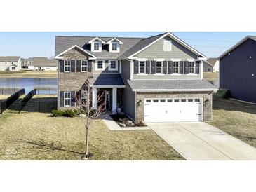 Beautiful two-story home with a two-car garage and well-manicured lawn at 6199 N Caraway Dr, McCordsville, IN 46055