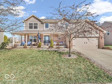 Charming two-story home with a well-manicured lawn and welcoming front porch with brick pillars at 6620 Avalon Blvd, Avon, IN 46123