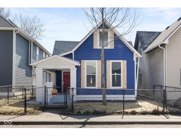 Charming two-story blue home with a well-manicured front yard and inviting curb appeal at 721 E Morris St, Indianapolis, IN 46203