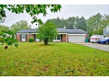 Charming single-story brick home with a well-manicured lawn and an attached two-car garage at 8172 Shottery Ter, Indianapolis, IN 46268