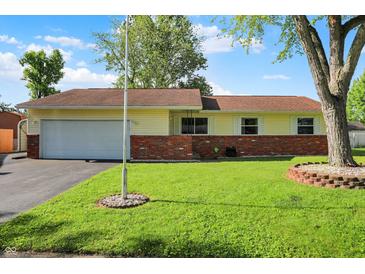 Charming ranch-style home featuring a well-manicured lawn and brick accents at 8715 Legion Ln, Indianapolis, IN 46231