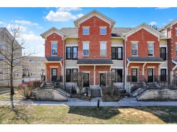 Charming townhomes feature brick facade, black accents, and inviting entryways at 1074 Reserve Way, Indianapolis, IN 46220