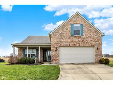 Charming brick home with a well-manicured lawn and two-car garage, perfect for suburban living at 129 W Clear Lake Ln, Westfield, IN 46074
