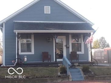 Charming blue bungalow with a cozy front porch and decorative accents at 1507 Hannibal St, Noblesville, IN 46060