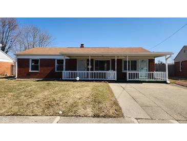 Charming brick home with a covered porch and well-manicured lawn, creating curb appeal at 2317 Courtney Rd, Indianapolis, IN 46219