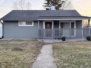 Charming single-story home with a covered front porch and well-maintained lawn at 3561 Bowen Pl, Indianapolis, IN 46221