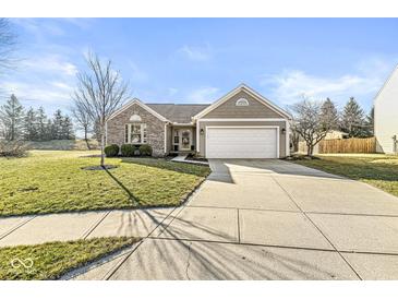 Charming home featuring a two-car garage, well-maintained lawn, and attractive landscaping at 481 Autumn Springs Ct, Avon, IN 46123
