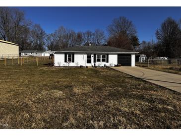 Charming single-story home with a well-manicured front yard and attached garage on a sunny day at 5061 N 200 W, Columbus, IN 47201
