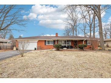 Charming brick ranch home with attached garage and well-maintained lawn, a perfect starter home at 5108 Chatham Pl, Indianapolis, IN 46226