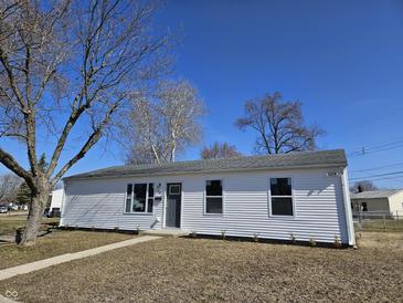 Charming one-story home with a well-manicured front lawn and mature trees at 702 Eberhart Dr, Shelbyville, IN 46176