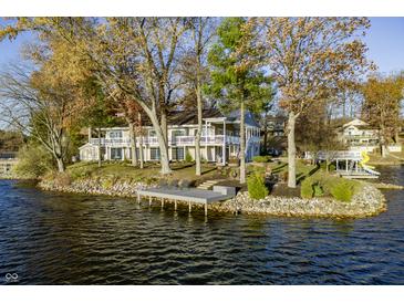 A beautiful waterfront home featuring a private dock and ample outdoor entertaining space at 7780 Paw Paw Dr, Nineveh, IN 46164