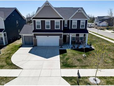 Beautiful two-story home with a well-maintained lawn and a spacious driveway at 8729 Dorill Creek Ln, Indianapolis, IN 46259